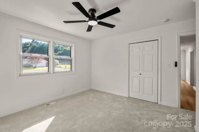 a view of an empty room with a window