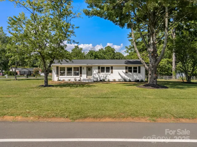 a front view of a house with swimming pool having outdoor seating