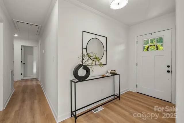 a view of an entryway with wooden floor