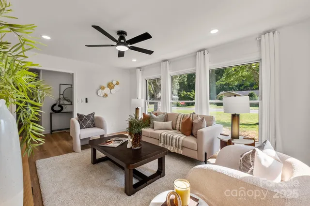 a living room with furniture and a large window