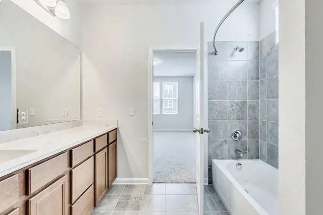 a bathroom with a bathtub and shower