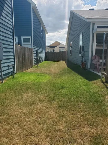 a view of a backyard of the house