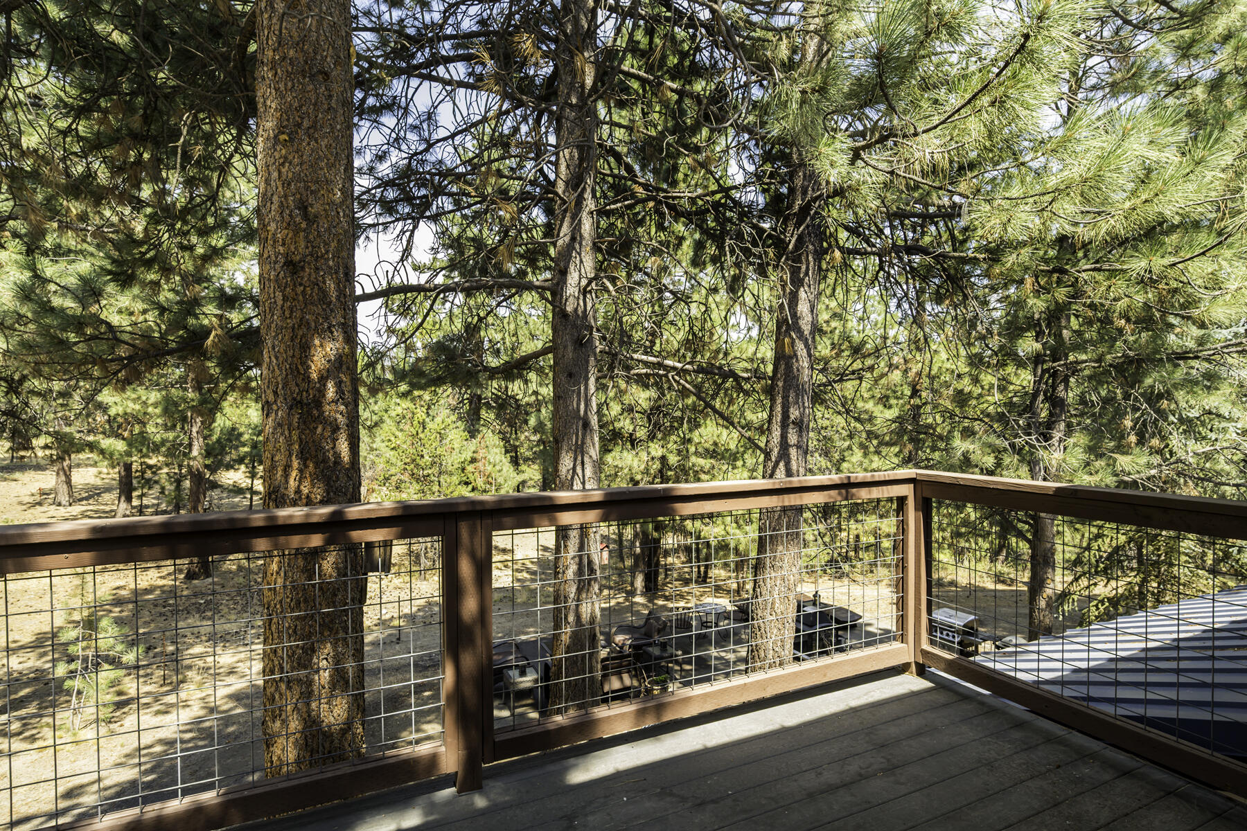 15730 Jackpine Road La Pine, OR 97739 - Photo 29 of 43 a view of roof deck with wooden floor and fence