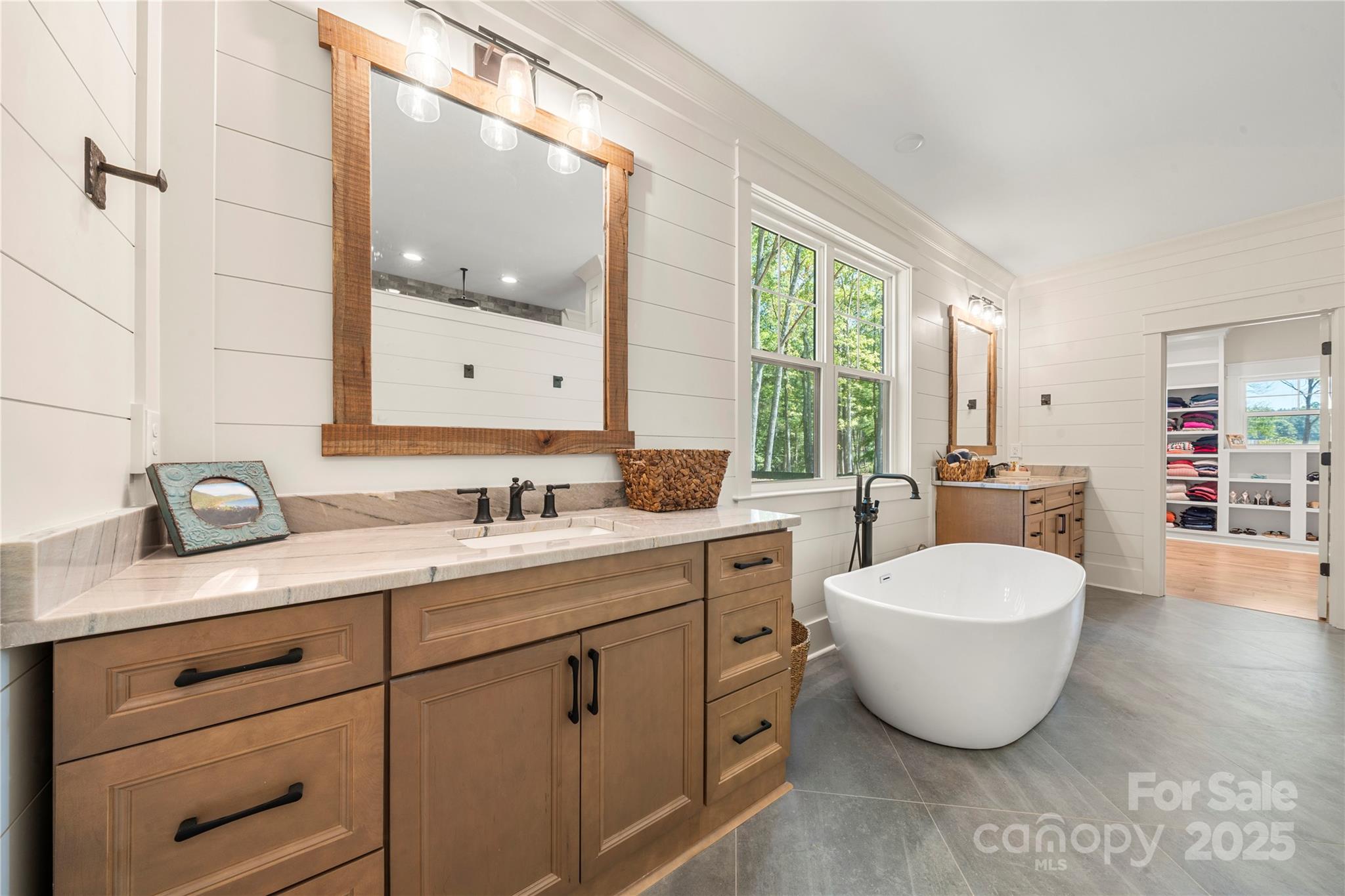 1033 Brandon Road Clover, SC 29710 - Photo 32 of 45 a spacious bathroom with a double vanity sink a mirror and a bathtub