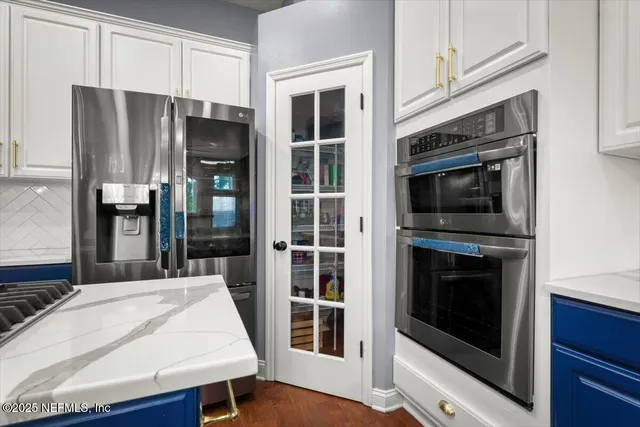 a kitchen with stainless steel appliances a stove a microwave and a refrigerator