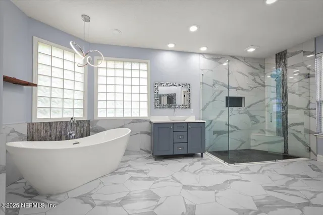 a large spacious bathroom with a bathtub and a shower