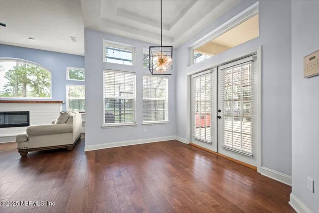 a view of a livingroom with furniture wooden floor and windows
