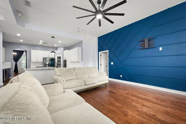 a living room with furniture and kitchen view