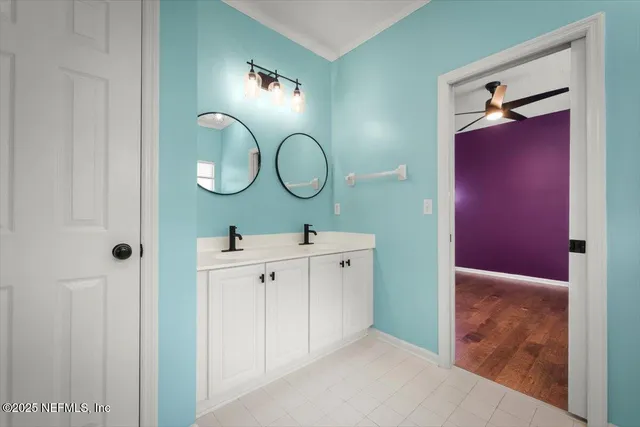 a bathroom with a double vanity sink and a mirror