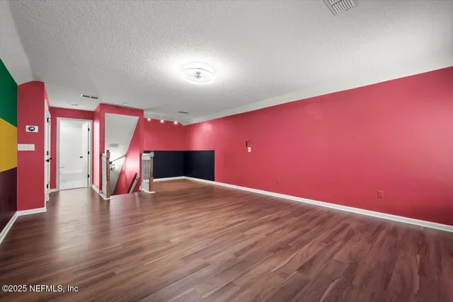 a view of a room with wooden floor