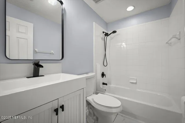 a bathroom with a sink toilet vanity and shower