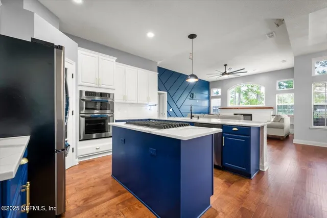 a kitchen with stainless steel appliances granite countertop a stove and refrigerator