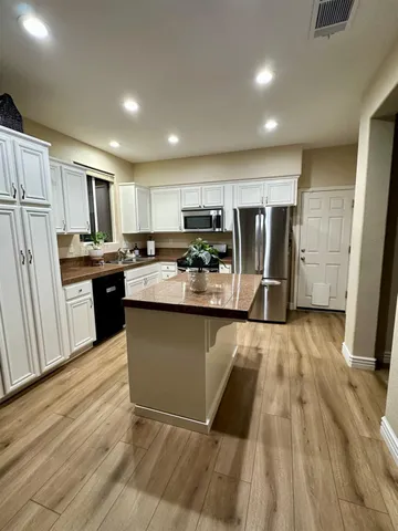 a kitchen with refrigerator and microwave