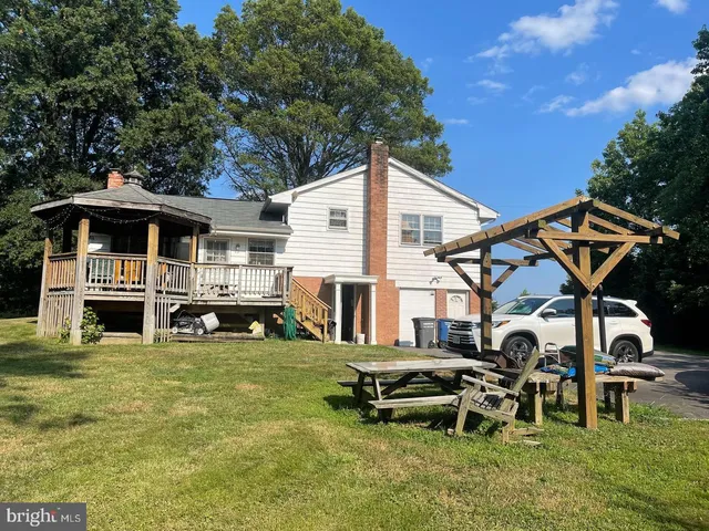 a view of a house with backyard porch and sitting area