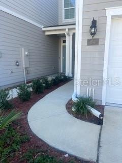 64 Redbud Road Palm Coast, FL 32137 - Photo 2 of 14 a view of a house with a small yard