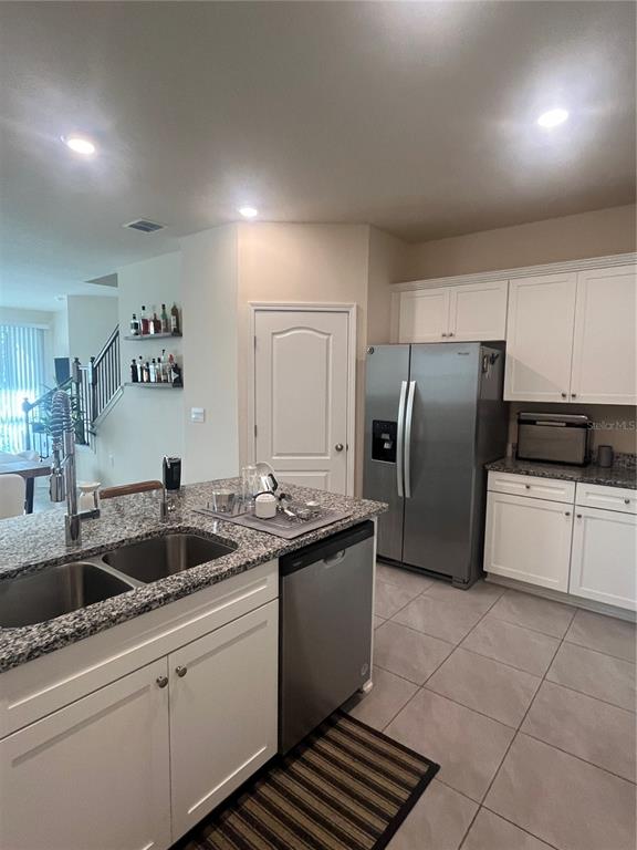 64 Redbud Road Palm Coast, FL 32137 - Photo 5 of 14 a kitchen that has a sink cabinets counter space and stainless steel appliances