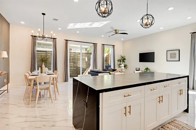 a kitchen with center island table and chairs in it