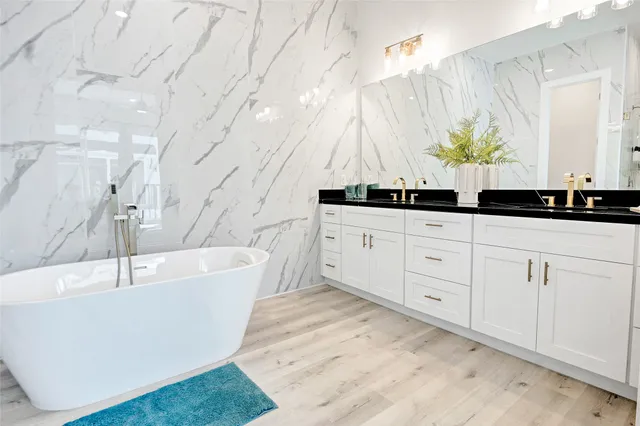 a bathroom with a bathtub and a sink