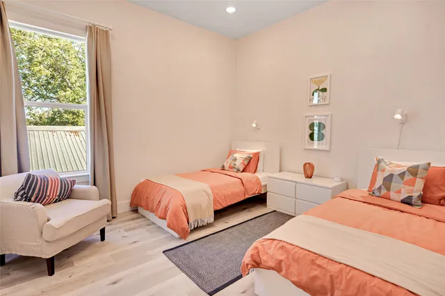 a bedroom with two beds and a couch