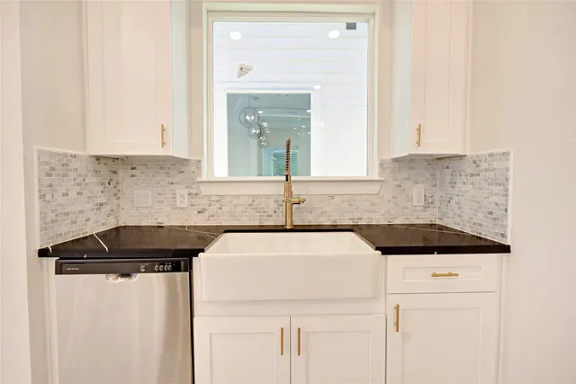 a kitchen with a sink and cabinets