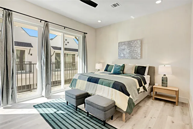 a bedroom with a bed and glass door