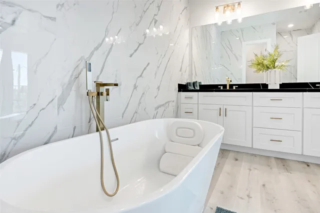 a spacious bathroom with a double vanity sink and a mirror