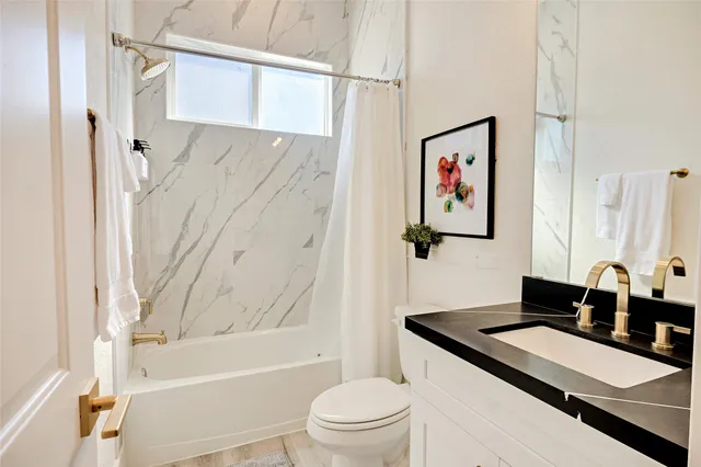 a bathroom with a sink a toilet and a bathtub