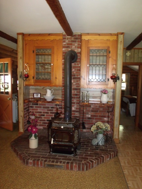 25 Lynch Road Wales, MA 01081 - Photo 17 of 28 a room with water heater and wooden floor