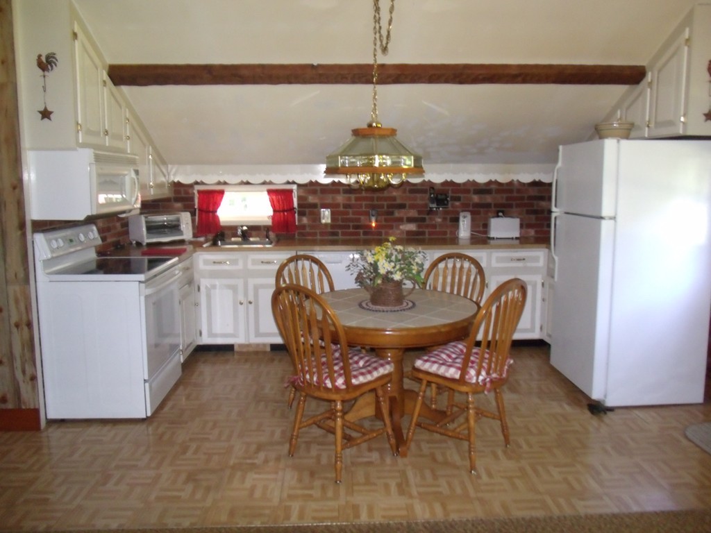 25 Lynch Road Wales, MA 01081 - Photo 20 of 28 a dining room with furniture and chandelier