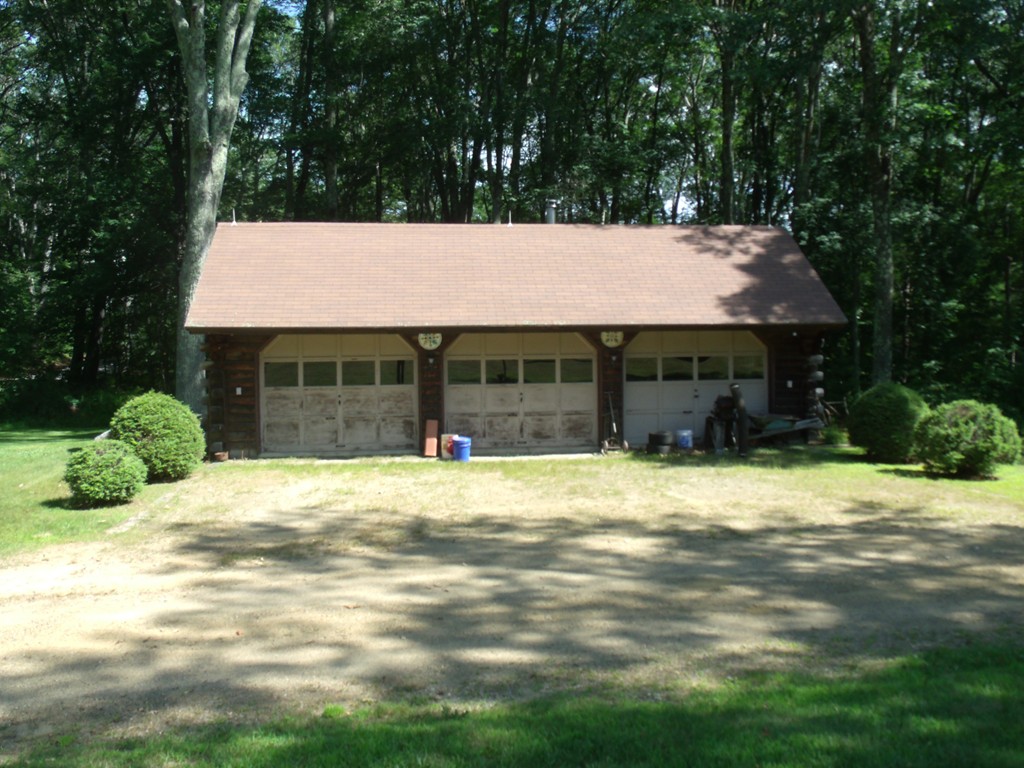 25 Lynch Road Wales, MA 01081 - Photo 4 of 28 a front view of a house with a yard and garage