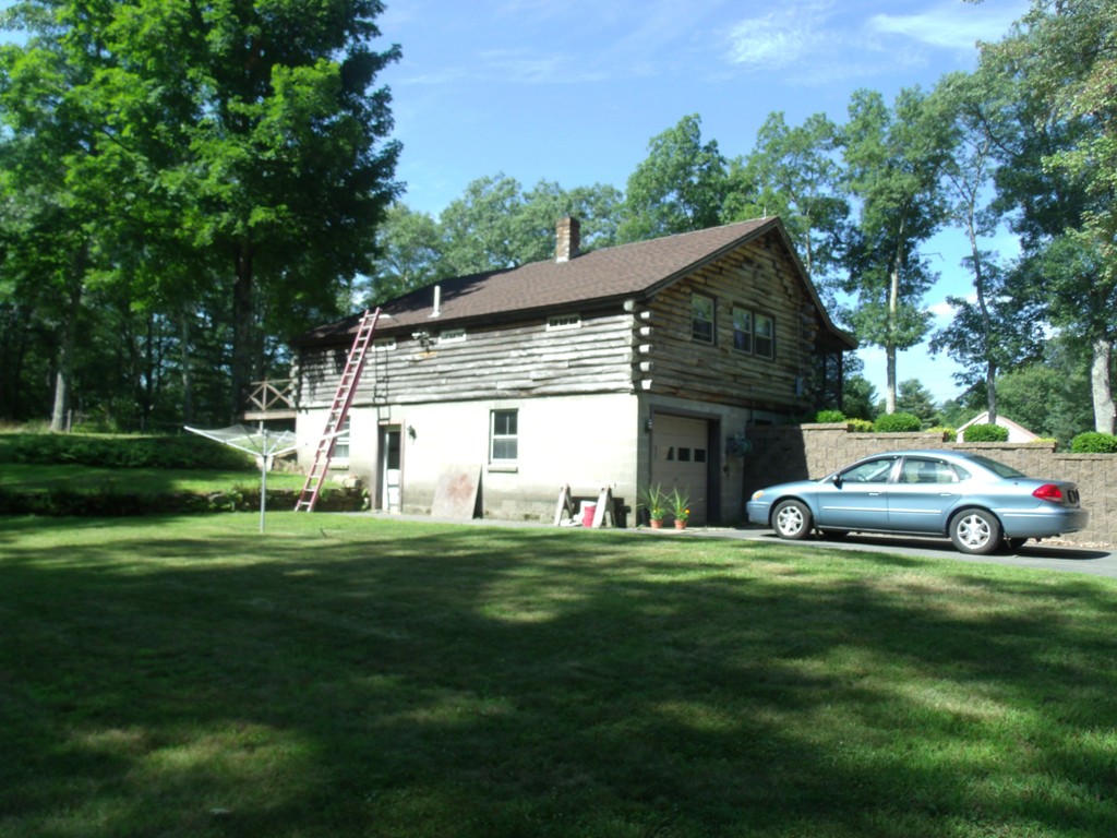 25 Lynch Road Wales, MA 01081 - Photo 9 of 28 a car parked in front of a house and a yard