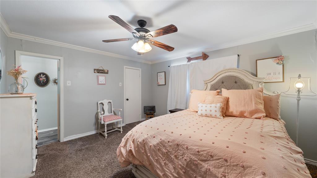 14260 North 3rd Street Scurry, TX 75158 - Photo 7 of 13 Bedroom featuring crown molding, dark carpet, and ceiling fan