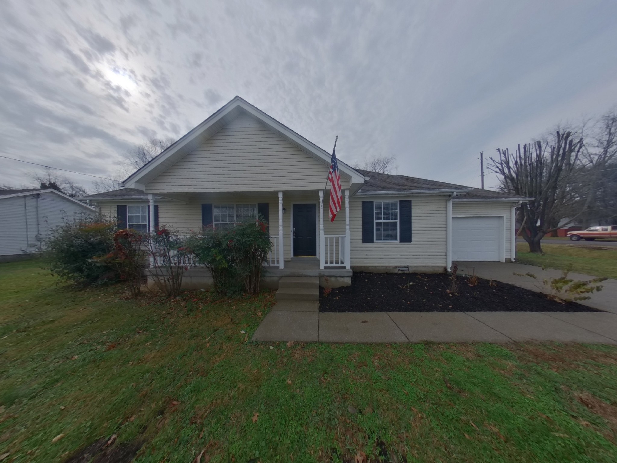 a front view of a house with a garden