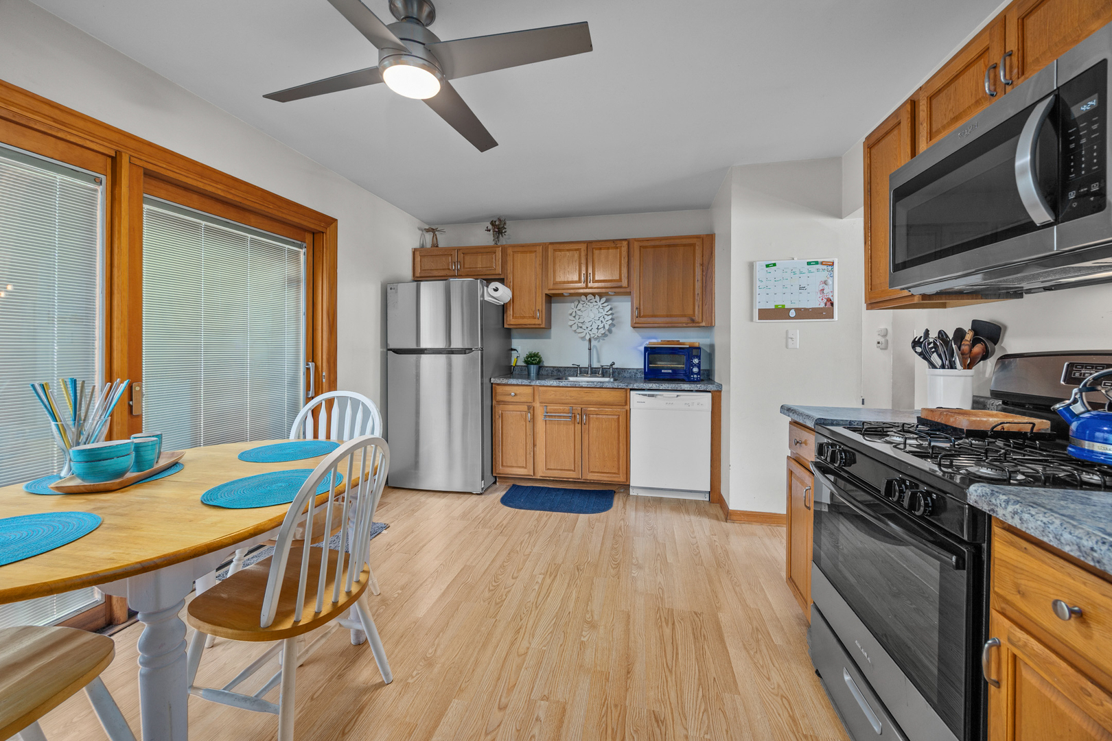 211 David Drive Streamwood, IL 60107 - Photo 6 of 24 a kitchen with stainless steel appliances granite countertop a stove top oven a refrigerator a sink with dining table and chairs