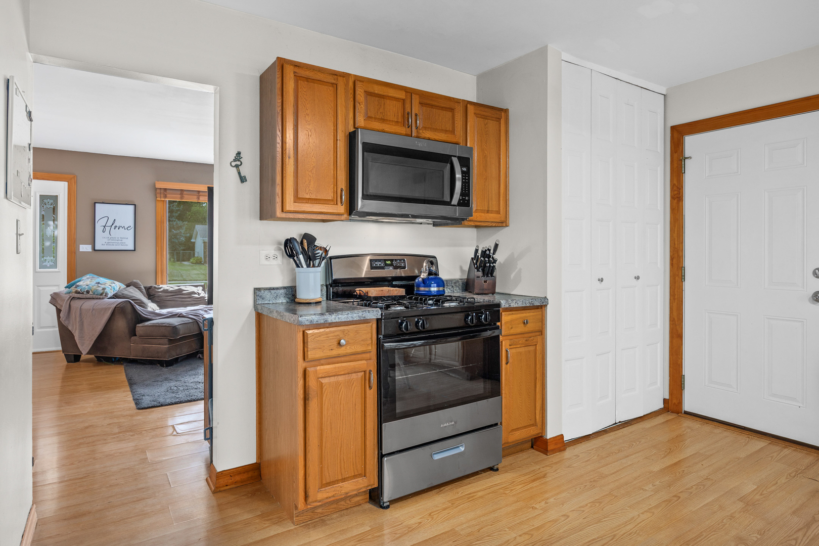 211 David Drive Streamwood, IL 60107 - Photo 9 of 24 a kitchen with stainless steel appliances granite countertop a stove and a microwave