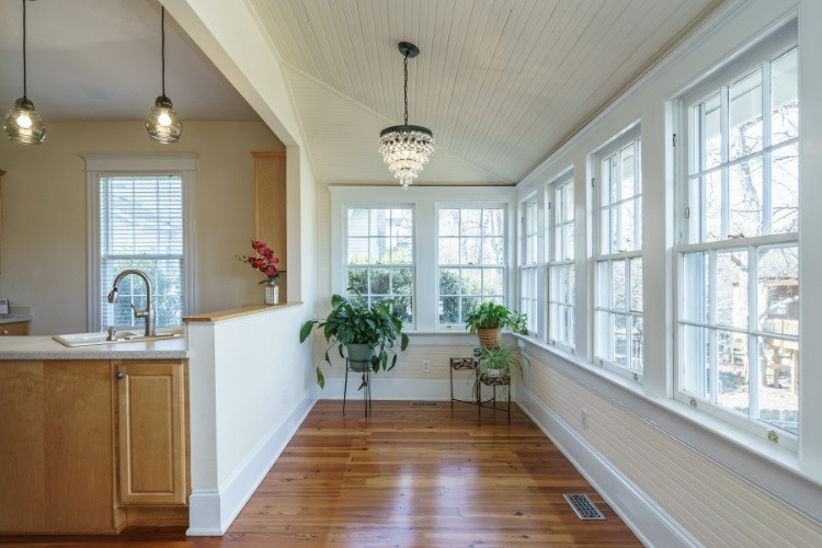 504 Cleveland Street Raleigh, NC 27605 - Photo 2 of 25 Bright and open describes the eat-in kitchen and breakfast/sun room with a wall of windows overlooking the back yard.