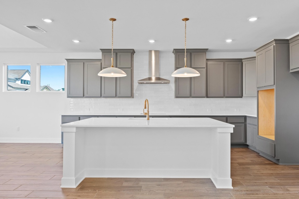 320 Buckaroo Drive Georgetown, TX 78633 - Photo 5 of 31 a kitchen with stainless steel appliances a stove refrigerator and couches