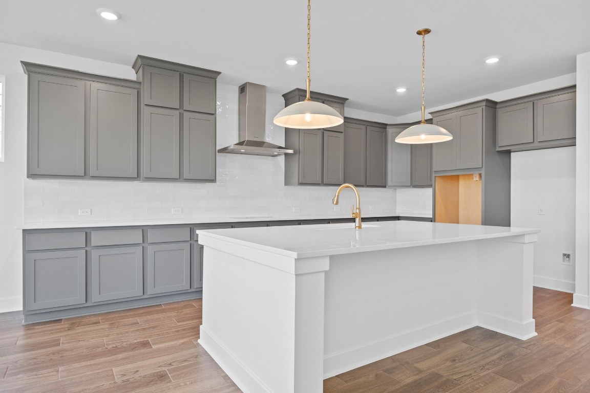 320 Buckaroo Drive Georgetown, TX 78633 - Photo 7 of 31 a kitchen with kitchen island a sink stainless steel appliances and cabinets
