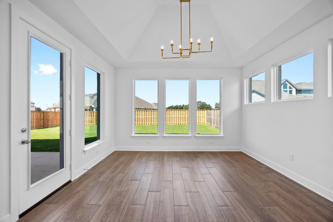 320 Buckaroo Drive Georgetown, TX 78633 - Photo 8 of 31 a view of an empty room with a window and wooden floor