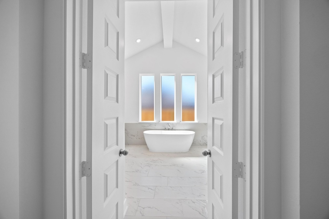 320 Buckaroo Drive Georgetown, TX 78633 - Photo 10 of 31 a bathroom with a white tub shower and sink