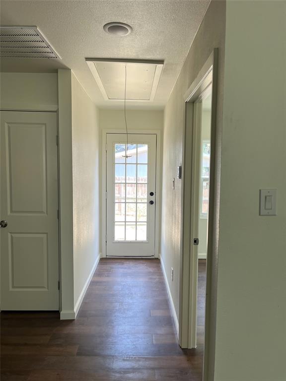 315 Hobson Street Weatherford, TX 76086 - Photo 9 of 24 a view of an empty room with wooden floor and a window