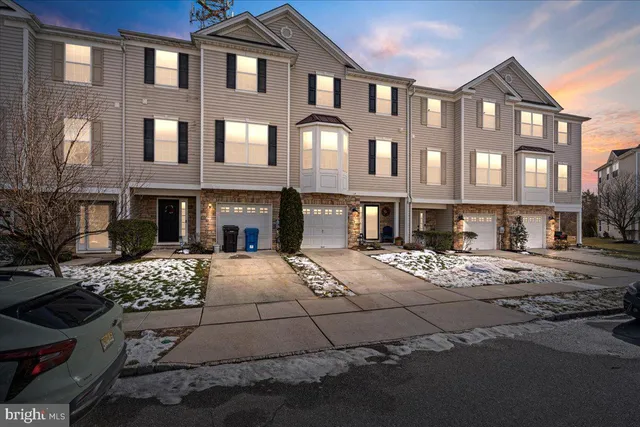 a front view of a house with outdoor seating