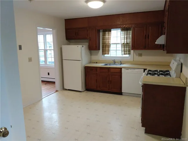 a kitchen with cabinets and window