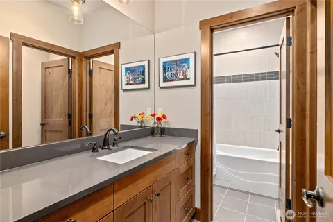 a bathroom with a granite countertop sink and a mirror