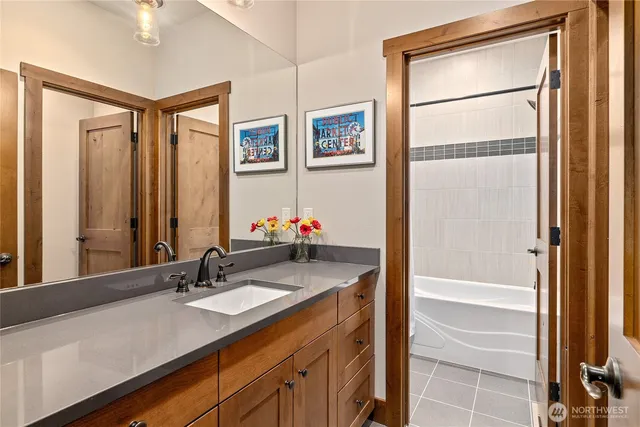 a bathroom with a granite countertop sink and a mirror