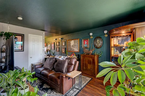 a living room with furniture and a clock