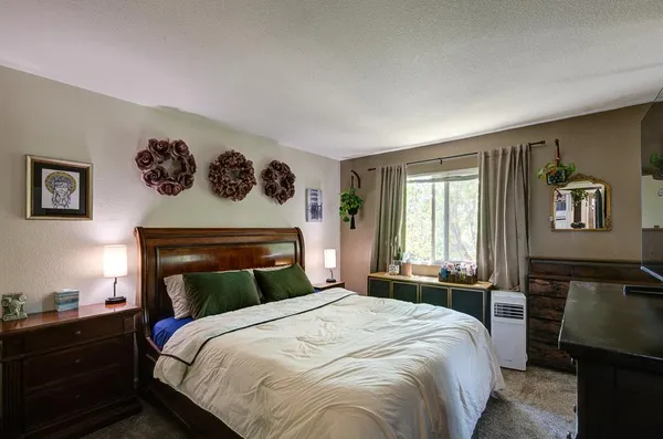 a bedroom with a bed and window