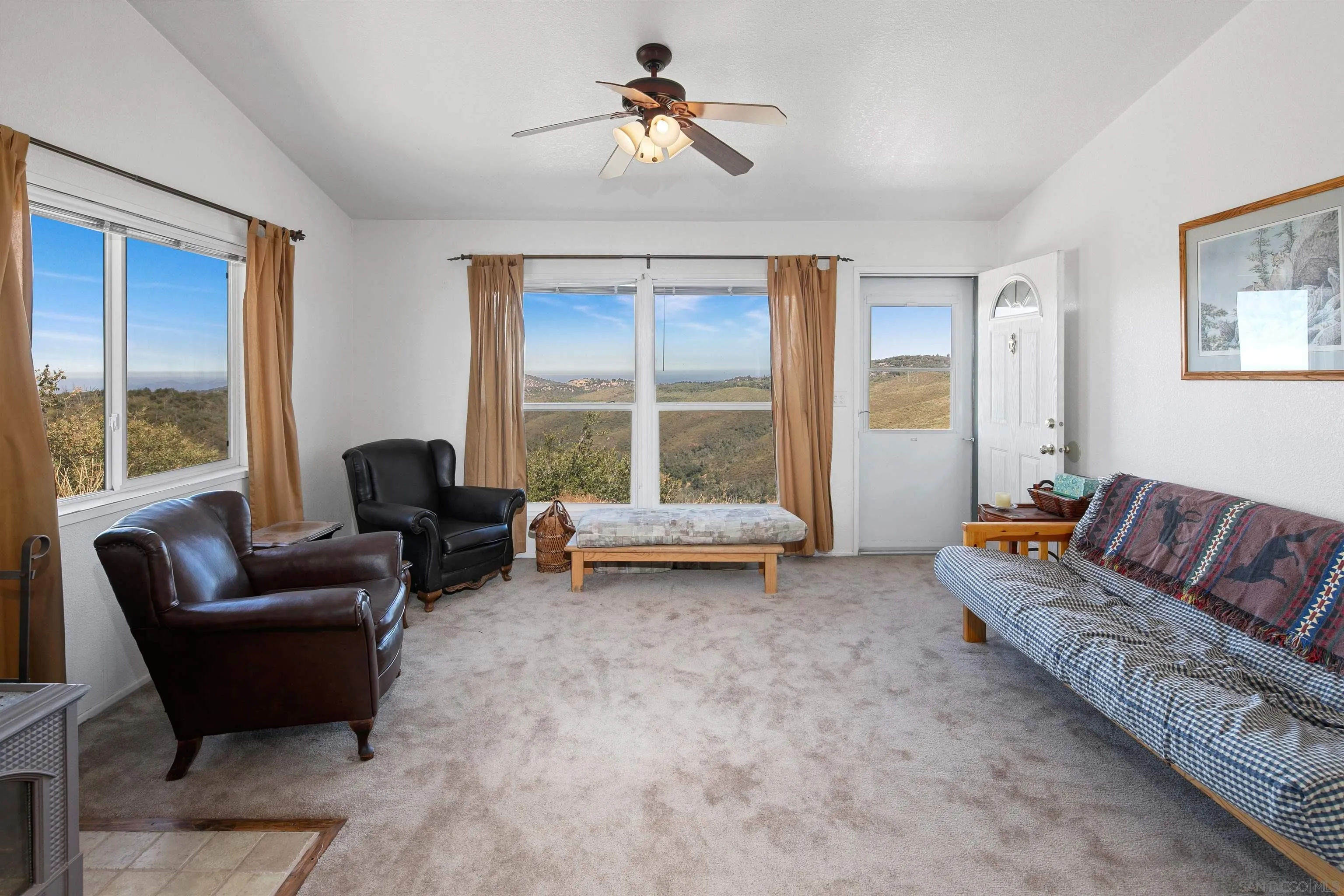 5017 Acorn Patch Road Julian, CA 92036 - Photo 2 of 12 a living room with furniture and a chandelier