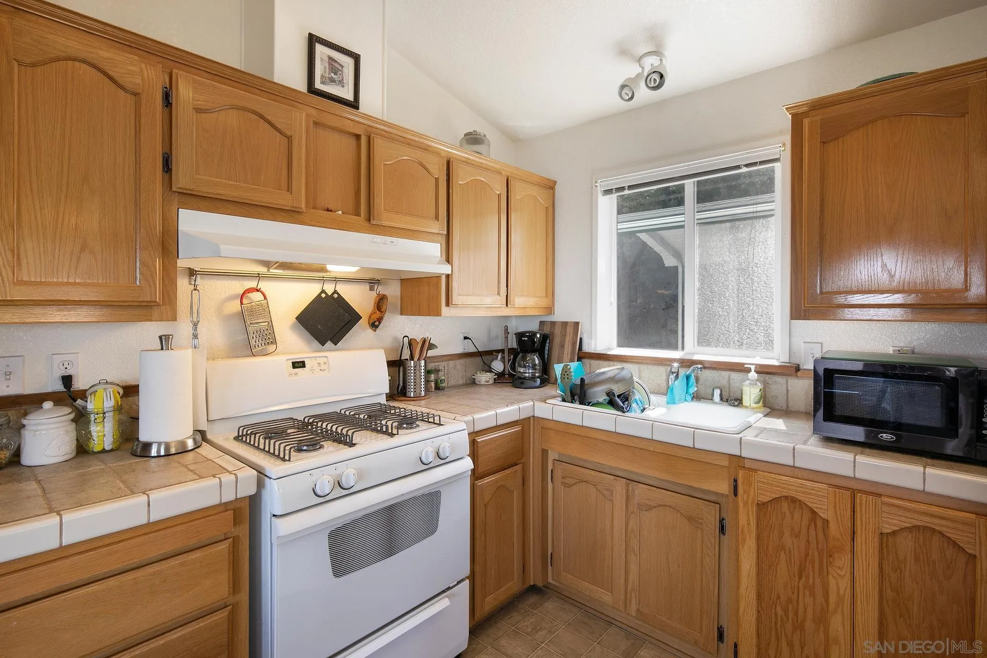 5017 Acorn Patch Road Julian, CA 92036 - Photo 4 of 12 a kitchen with granite countertop a sink stove and cabinets