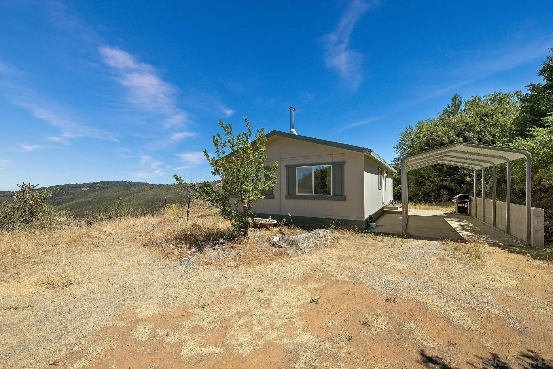 5017 Acorn Patch Road Julian, CA 92036 - Photo 5 of 12 a backyard of a house with yard and outdoor seating